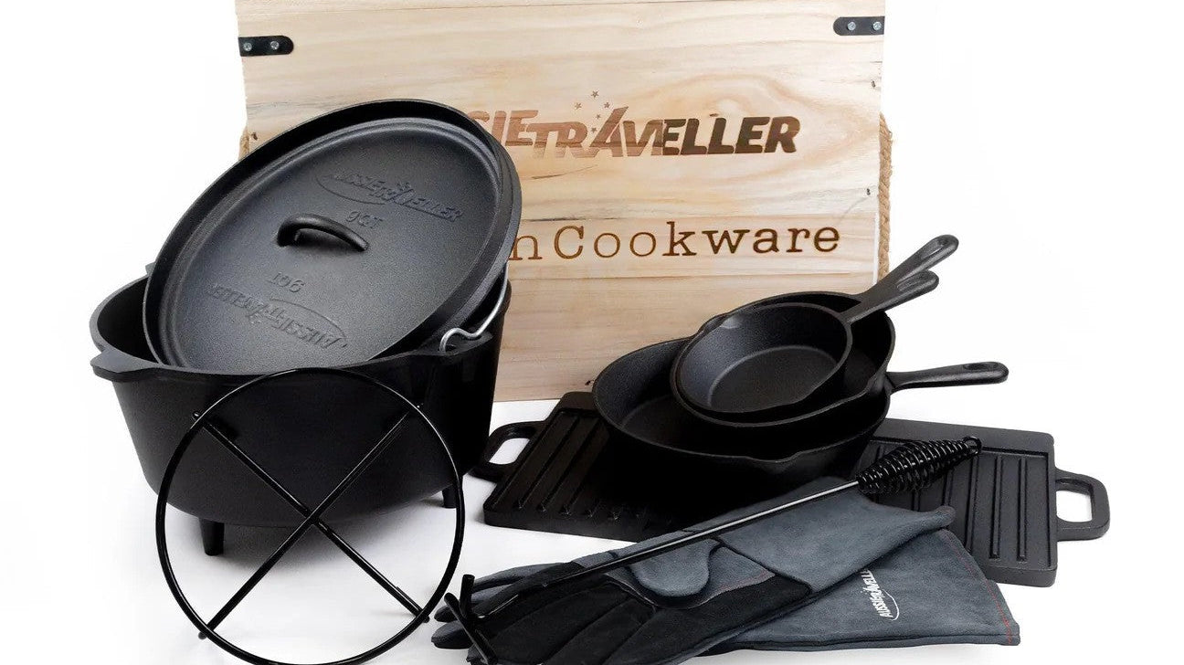 A black cast iron cookware set neatly arranged in a wooden box, highlighting its durable construction and classic style.